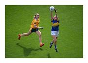 5 September 2021; The juniors are first into action in the ladies football All-Ireland finals day in Croke Park. Wicklow’s Clodagh Fox, who scored 1-3 on the day, gets out in front of Antrim’s Duana Coleman to make a fine catch and, afterwards, Sarah Jane Winders oversees the captain’s ceremonial honours by raising the West County Hotel Cup. Photo by Stephen McCarthy/Sportsfile This image may be reproduced free of charge when used in conjunction with a review of the book &quot;A Season of Sundays 2020&quot;. All other usage © Sportsfile