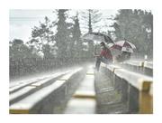 4 July 2021; It’s great to be back. Honest. Galway supporter Des Casey from Ballybane, left, shelters from the deluge at Dr Hyde Park before the game. Global warming will make us appreciate the covered stand. Photo by Sam Barnes/Sportsfile This image may be reproduced free of charge when used in conjunction with a review of the book &quot;A Season of Sundays 2020&quot;. All other usage © Sportsfile