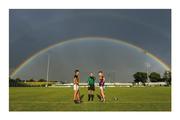 28 July 2021; Somewhere under the rainbow. Nature provides the perfect setting – a multi-coloured domed roof – in Carlow for one of Leinster’s great rivalries. Kilkenny minor hurling captain Harry Shine and his opposite number, Wexford’s Luke Murphy, wait to see how referee Thomas Gleeson’s coin lands before choosing ends. No crock of gold for the winners but they’ll settle for silverware. Photo by Matt Browne/Sportsfile This image may be reproduced free of charge when used in conjunction with a review of the book &quot;A Season of Sundays 2020&quot;. All other usage © Sportsfile