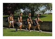 30 May 2021; All togged out – apart from the boots – and somewhere to go. Conor Fogarty, right, leads his Kilkenny team-mates Conor Browne, Pádraig Walsh, TJ Reid and Huw Lawlor along O’Loughlin Road en route to Nowlan Park. Photo by Ray McManus/Sportsfile This image may be reproduced free of charge when used in conjunction with a review of the book &quot;A Season of Sundays 2020&quot;. All other usage © Sportsfile