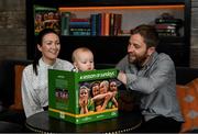 15 November 2021; Senan Daly, aged seven months, from Glasnevin, Dublin, reads A Season of Sundays with his parents Colleen Fahey and Sportsfile Photographer Seb Daly at the launch of A Season of Sundays 2021 at Croke Park Hotel in Dublin. Photo by Harry Murphy/Sportsfile