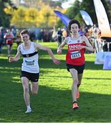21 November 2021; Gavin Curtin of Donore Harriers, Dublin, left, and Dylan Casey of Ennis Track AC, Clare, competing in the Junior Men's event during the Irish Life Health National Cross Country Championships at Santry Demense in Dublin. Photo by Ramsey Cardy/Sportsfile