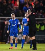 26 November 2021; Niall O'Keeffe of Waterford, left, receives a red card from referee Paul McLaughlin during the SSE Airtricity League Promotion / Relegation Play-off Final between UCD and Waterford at Richmond Park in Dublin. Photo by Stephen McCarthy/Sportsfile