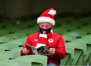 28 November 2021; A St Patrick's Athletic supporter reads the match programme before the Extra.ie FAI Cup Final match between Bohemians and St Patrick's Athletic at Aviva Stadium in Dublin. Photo by Michael P Ryan/Sportsfile