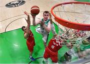 28 November 2021; John Carroll of Ireland goes for a basket despite the efforts of Renato Poljak, left, and Thomas Klepiesz of Austria during the FIBA EuroBasket 2025 Pre-Qualifiers First Round Group A match between Ireland and Austria at National Basketball Arena in Tallaght, Dublin. Photo by Brendan Moran/Sportsfile