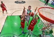28 November 2021; John Carroll of Ireland goes for a basket despite the efforts of Renato Poljak, left, and Thomas Klepiesz of Austria during the FIBA EuroBasket 2025 Pre-Qualifiers First Round Group A match between Ireland and Austria at National Basketball Arena in Tallaght, Dublin. Photo by Brendan Moran/Sportsfile