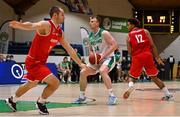 28 November 2021; John Carroll of Ireland in action against Jakob Szkutta, left, and Guylain Mbemba of Austria during the FIBA EuroBasket 2025 Pre-Qualifiers First Round Group A match between Ireland and Austria at National Basketball Arena in Tallaght, Dublin. Photo by Brendan Moran/Sportsfile