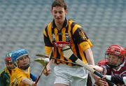 30 March 2004; McDonald's Restaurants of Ireland and the GAA today launched an innovative campaign to improve the hurling and camogie skills of thousands of primary school children across Ireland. Pictured at the launch are Kilkenny captain Martin Comerford under pressure from Sean Healy, left, Dublin, and Conor Murphy, Dublin. Croke Park, Dublin. Picture credit; David Maher / SPORTSFILE *EDI*