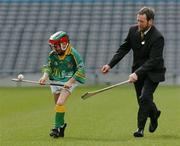 30 March 2004; McDonald's Restaurants of Ireland and the GAA today launched an innovative campaign to improve the hurling and camogie skills of thousands of primary school children across Ireland. Pictured at the launch is 8 year old James Tyrrell, Dublin, in action against GAA President Sean Kelly. Croke Park, Dublin. Picture credit; David Maher / SPORTSFILE *EDI*