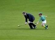 30 March 2004; McDonald's Restaurants of Ireland and the GAA today launched an innovative campaign to improve the hurling and camogie skills of thousands of primary school children across Ireland. Pictured at the launch is GAA President Sean Kelly in action against James Tyrrell, Dublin. Croke Park, Dublin. Picture credit; Ray McManus / SPORTSFILE *EDI*