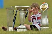 24 July 2013; Mikey Gorman, from Tullow, Co. Carlow, with, from left, the British & Irish Cup, Amlin Challenge Cup, and the Rabodirect Pro12 Cup during a Leinster Rugby Summer Camp at Tullow RFC. Tullow RFC, Tullow, Co. Carlow. Picture credit: Matt Browne / SPORTSFILE