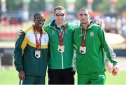 26 July 2013; Team Ireland’s Jason Smyth, from Eglinton, Co. Derry, celebrates with his gold medal in the Men’s 100m – T13 final where he finished with a championship record time of 10:61, alongside second place Jonathan Ntutu, South Africa, left, and third place Radoslav Zlatanov, Bulgaria, right. 2013 IPC Athletics World Championships, Stadium Parilly, Lyon, France. Picture credit: John Paul Thomas / SPORTSFILE