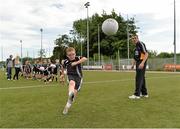 27 July 2013; Kildare footballer John Doyle and former Kilkenny hurler Martin Comerford supporting the Opel Kit for Clubs Blitz Day in St. Brigids GAA Club, Blanchardstown. Kildare footballer John Doyle looks on at Luis O'Carrol age 8 from St. Peregrines GAA CLub, Clonsilla, during a skills session. For every test drive, car service or Opel purchase made through the Opel dealer network, your local GAA club is awarded points. Build up your points and redeem them against high quality kit for your club! Log onto opelkitforclubs.com http://opelkitforclubs.com and start earning points today.  Support your local GAA club! St. Brigid's GAA Club, Blanchardstown, Dublin. Picture credit: Barry Cregg / SPORTSFILE