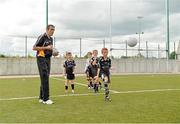 27 July 2013; Kildare footballer John Doyle and former Kilkenny hurler Martin Comerford supporting the Opel Kit for Clubs Blitz Day in St. Brigids GAA Club, Blanchardstown. Kildare footballer John Doyle gives instructions to children from St. Peregrines GAA Club, Clonsilla, during a skills session. For every test drive, car service or Opel purchase made through the Opel dealer network, your local GAA club is awarded points. Build up your points and redeem them against high quality kit for your club! Log onto opelkitforclubs.com http://opelkitforclubs.com and start earning points today.  Support your local GAA club! St. Brigid's GAA Club, Blanchardstown, Dublin. Picture credit: Barry Cregg / SPORTSFILE