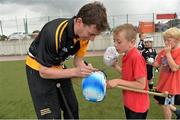 27 July 2013; Kildare footballer John Doyle and former Kilkenny hurler Martin Comerford supporting the Opel Kit for Clubs Blitz Day in St. Brigids GAA Club, Blanchardstown. Former Kilkenny hurler Martin Comerford autographs Gavin Markey, age 8, from St. Peregrines GAA Club, Clonsilla, Dublin. For every test drive, car service or Opel purchase made through the Opel dealer network, your local GAA club is awarded points. Build up your points and redeem them against high quality kit for your club! Log onto opelkitforclubs.com http://opelkitforclubs.com and start earning points today.  Support your local GAA club! St. Brigid's GAA Club, Blanchardstown, Dublin. Picture credit: Barry Cregg / SPORTSFILE