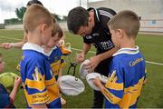 27 July 2013; Kildare footballer John Doyle and former Kilkenny hurler Martin Comerford supporting the Opel Kit for Clubs Blitz Day in St. Brigids GAA Club, Blanchardstown. Kildare footballer John Doyle signs autographs for children from Castleknock GAA Club. For every test drive, car service or Opel purchase made through the Opel dealer network, your local GAA club is awarded points. Build up your points and redeem them against high quality kit for your club! Log onto opelkitforclubs.com http://opelkitforclubs.com and start earning points today.  Support your local GAA club! St. Brigid's GAA Club, Blanchardstown, Dublin. Picture credit: Barry Cregg / SPORTSFILE