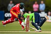 29 August 2021; Ireland wicketkeeper Neil Rock attempts to run-out Zimbabwe's Dion Myers during match two of the Dafanews T20 series between Ireland and Zimbabwe at Clontarf Cricket Club in Dublin. Photo by Seb Daly/Sportsfile