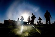 5 December 2021; Kilmacud Crokes players are silhouetteed against the mid day sun as they warm up before the AIB Leinster GAA Football Senior Club Championship Quarter-Final match between Wolfe Tones and Kilmacud Crokes at Páirc Tailteann in Navan, Meath. Photo by Ray McManus/Sportsfile