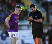 5 December 2021; Niall O’Reilly of Wolfe Tones has his name taken by referee Patrick Maguire before receiving a yellow card during the AIB Leinster GAA Football Senior Club Championship Quarter-Final match between Wolfe Tones and Kilmacud Crokes at Páirc Tailteann in Navan, Meath. Photo by Ray McManus/Sportsfile