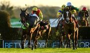 5 December 2021; Jockey Eoin Walsh is unseated from John Adams, left, as eventual winner Glenquin Castle, right, with Mark Walsh up, race clear to win the Hanlon Concrete Handicap Steeplechase at Punchestown Racecourse in Kildare. Photo by Seb Daly/Sportsfile