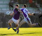 5 December 2021; Thomas O’Reilly of Wolfe Tones is tackled by Aidan Jones of Kilmacud Crokes during the AIB Leinster GAA Football Senior Club Championship Quarter-Final match between Wolfe Tones and Kilmacud Crokes at Páirc Tailteann in Navan, Meath. Photo by Ray McManus/Sportsfile