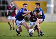 5 December 2021; Jake Foster of Portarlington in action against Oisin Hogan and Kelvin Reilly of St Loman's during the AIB Leinster GAA Football Senior Club Championship Quarter-Final match between Portarlington and St Loman's at MW Hire O’Moore Park in Portlaoise, Laois. Photo by Matt Browne/Sportsfile