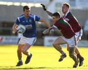 5 December 2021; John Heslin of St Loman's in action against Stuart Mulpeter and Adam Ryan of Portarlington during the AIB Leinster GAA Football Senior Club Championship Quarter-Final match between Portarlington and St Loman's at MW Hire O’Moore Park in Portlaoise, Laois. Photo by Matt Browne/Sportsfile