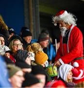 11 December 2021; A supporter dressed as Father Christmas offers sweets to supporters in the stands before the AIB Connacht GAA Football Senior Club Championship Semi-Final match between Pádraig Pearses and Mountbellew/Moylough at Dr Hyde Park in Roscommon. Photo by Eóin Noonan/Sportsfile