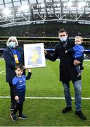 11 December 2021; Former Leinster player Fergus McFadden with his sons Freddie and Alfie is presented a print by Liz Power of the OLSC during the Heineken Champions Cup Pool A match between Leinster and Bath at Aviva Stadium in Dublin. Photo by Harry Murphy/Sportsfile