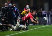 11 December 2021; Ethan McIlroy of Ulster is tackled by Alivereti Raka of Clermont Auvergne during the Heineken Champions Cup Pool A match between ASM Clermont Auvergne and Ulster at Stade Marcel-Michelin in Clermont-Ferrand, France. Photo by Julien Poupart/Sportsfile
