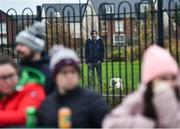 11 December 2021; A spectator and his dog watch from outside the ground during the match between Meath and TG4 Underdogs at Donaghmore Ashbourne GAA club in Ashbourne, Meath. Photo by David Fitzgerald/Sportsfile