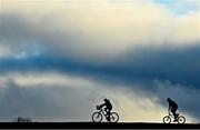 15 December 2021; Cyclists cycle past Munster Rugby squad training at the University of Limerick in Limerick. Photo by Brendan Moran/Sportsfile