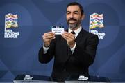 16 December 2021; Special guest Robert Pirès draws out the card of Northern Ireland during the UEFA Nations League 2022/23 League Phase Draw at the UEFA headquarters, The House of European Football in Nyon, Switzerland. Photo by Richard Juilliart / UEFA via Sportsfile