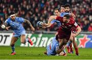 18 December 2021; Chris Farrell of Munster offloads in the tackle by Thomas Combezou of Castres Olympique  during the Heineken Champions Cup Pool B match between Munster and Castres Olympique at Thomond Park in Limerick. Photo by Brendan Moran/Sportsfile