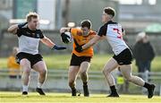19 December 2021; Darragh O'Brien of Austin Stacks is tackled by James Kelly and Darren O’Doherty of Newcastlewest during the AIB Munster GAA Football Senior Club Football Championship Semi-Final match between Austin Stacks and Newcastle West at Austin Stack Park in Tralee, Kerry. Photo by Brendan Moran/Sportsfile