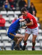 19 December 2021; Niall McMahon of Eire Óg Ennis in action against Colm Scully of St Finbarr's during the AIB Munster GAA Football Senior Club Football Championship Semi-Final match between St. Finbarr's and Éire Óg Ennis at Pairc Ui Rinn in Cork. Photo by Eóin Noonan/Sportsfile