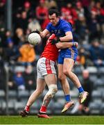 19 December 2021; Conor McCrickard of St Finbarr's in action against Aaron Fitzgerald of Eire Óg Ennis during the AIB Munster GAA Football Senior Club Football Championship Semi-Final match between St. Finbarr's and Éire Óg Ennis at Pairc Ui Rinn in Cork. Photo by Eóin Noonan/Sportsfile