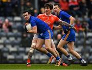 19 December 2021; Conor McCrickard of St Finbarr's in action against Aaron Fitzgerald of Eire Óg Ennis during the AIB Munster GAA Football Senior Club Football Championship Semi-Final match between St. Finbarr's and Éire Óg Ennis at Pairc Ui Rinn in Cork. Photo by Eóin Noonan/Sportsfile