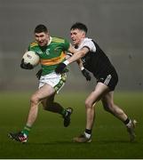 19 December 2021; Ciaran McFaul of Glen in action against Michael Rooney of Kilcoo during the AIB Ulster GAA Football Club Senior Championship Semi-Final match between Glen and Kilcoo at Athletic Grounds in Armagh. Photo by David Fitzgerald/Sportsfile