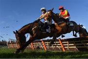 29 December 2021; Shewearsitwell and jockey Paul Townend, left, narrowly avoid falling as they jump the third, alongside Dime A Dozen, with Tony Hamilton up, during the Advent Surety Irish EBF Mares Hurdle on day four of the Leopardstown Christmas Festival at Leopardstown Racecourse in Dublin. Photo by Seb Daly/Sportsfile