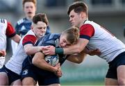 4 January 2022; Edgaras Kucinkas of Metro is tackled by Rory Allen, left, and Conor Moore of Midlands during the Bank of Ireland Leinster Rugby Shane Horgan Cup Round 4 match between Metro and Midlands at Energia Park in Dublin. Photo by Piaras Ó Mídheach/Sportsfile