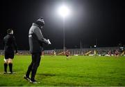 7 January 2022; Anthony Doherty of Down kicks a free as Donegal manager Declan Bonner watches on during the Dr McKenna Cup Round 1 match between Donegal and Down at Pairc MacCumhaill in Ballybofey, Donegal. Photo by Ramsey Cardy/Sportsfile