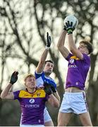 8 January 2022; Liam Coleman, right, ands Darragh Lyons of Wexford in action against James Finn of Laois at the throw-in of their O'Byrne Cup group B match between Wexford and Laois at Hollymount in Galbally, Wexford. Photo by Seb Daly/Sportsfile