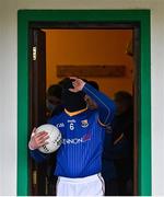 8 January 2022; Longford captain Michael Quinn removes his face covering as he leads his side out from the dressing room before the O'Byrne Cup group A match between Longford and Louth at Rathcline GAA club in Lanesboro, Longford. Photo by Ramsey Cardy/Sportsfile