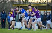 8 January 2022; Brian Daly of Laois in action against Wexford players, from left, Kevin O’Grady, Rian Fitzpatrick and Ben Brosnan during the O'Byrne Cup group B match between Wexford and Laois at Hollymount in Galbally, Wexford. Photo by Seb Daly/Sportsfile