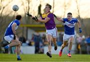 8 January 2022; Liam Coleman of Wexford in action against Patrick O'Sullivan, right, and Gareth Dillon of Laois during the O'Byrne Cup group B match between Wexford and Laois at Hollymount in Galbally, Wexford. Photo by Seb Daly/Sportsfile