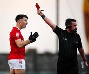 8 January 2022; Tadhg Corkery of Cork is shown a red card by referee Seamus Mulvihill during the McGrath Cup group A match between Clare and Cork at Hennessy Memorial Park in Miltown Malbay, Clare. Photo by Stephen McCarthy/Sportsfile