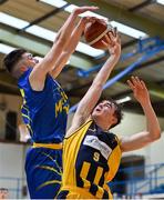 9 January 2022; Oisin Flynn of Killorglin CYMS has a shot blocked by Ronan Byrne of UCD Marian during the Basketball Ireland Men's U20 Cup semi-final match between UCD Marian and Killorglin CYMS at Neptune Stadium in Cork. Photo by Brendan Moran/Sportsfile