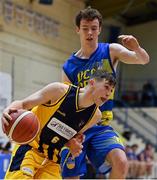 9 January 2022; Sean O'Brien of Killorglin CYMS in action against Colm O'Reilly of UCD Marian during the Basketball Ireland Men's U20 Cup semi-final match between UCD Marian and Killorglin CYMS at Neptune Stadium in Cork. Photo by Brendan Moran/Sportsfile