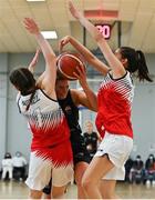 9 January 2022; Gillian Wheeler of Portlaoise Panthers in action against Issy McSweeney, left, and Mia Finnegan of Singleton SuperValu Brunell during the Basketball Ireland Women's U20 semi-final match between Singleton Supervalu Brunell and Portlaoise Panthers at Parochial Hall in Cork. Photo by Sam Barnes/Sportsfile